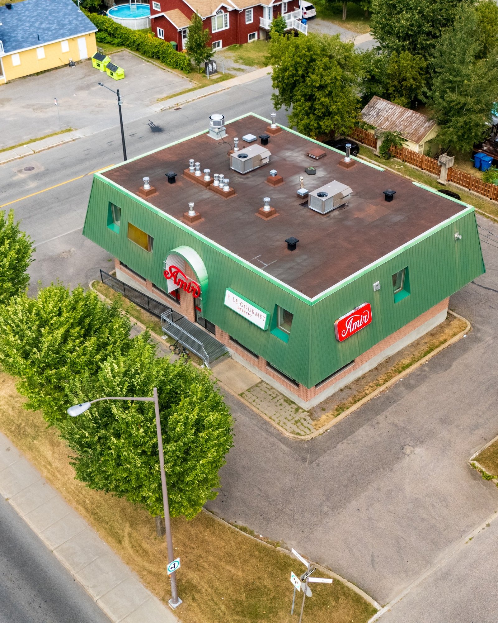 Aerial view of a commercial building with a green roof