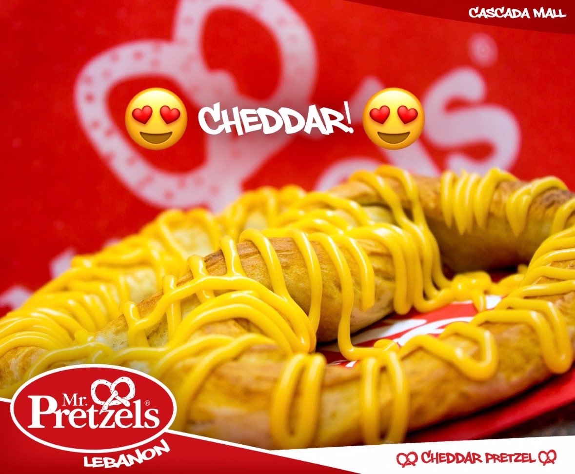A social media post showcasing a cheese pretzel.