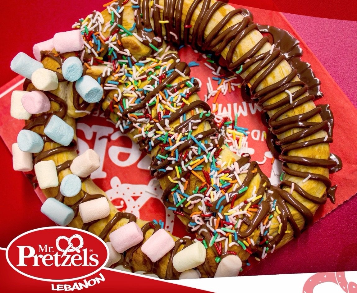 A pretzel with chocolate and marshmallows.