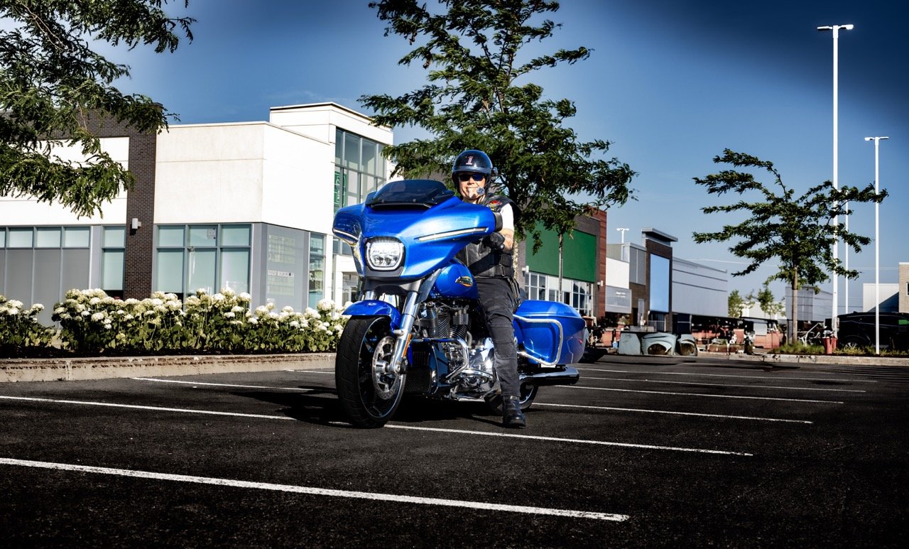 A custom blue motorcycle parked outdoors.