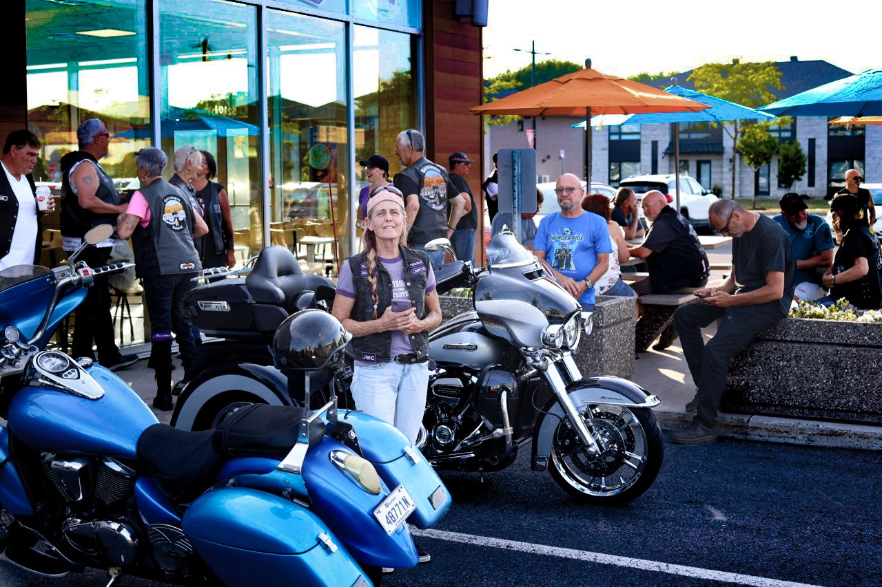 A crowd of people and bikes at an event.