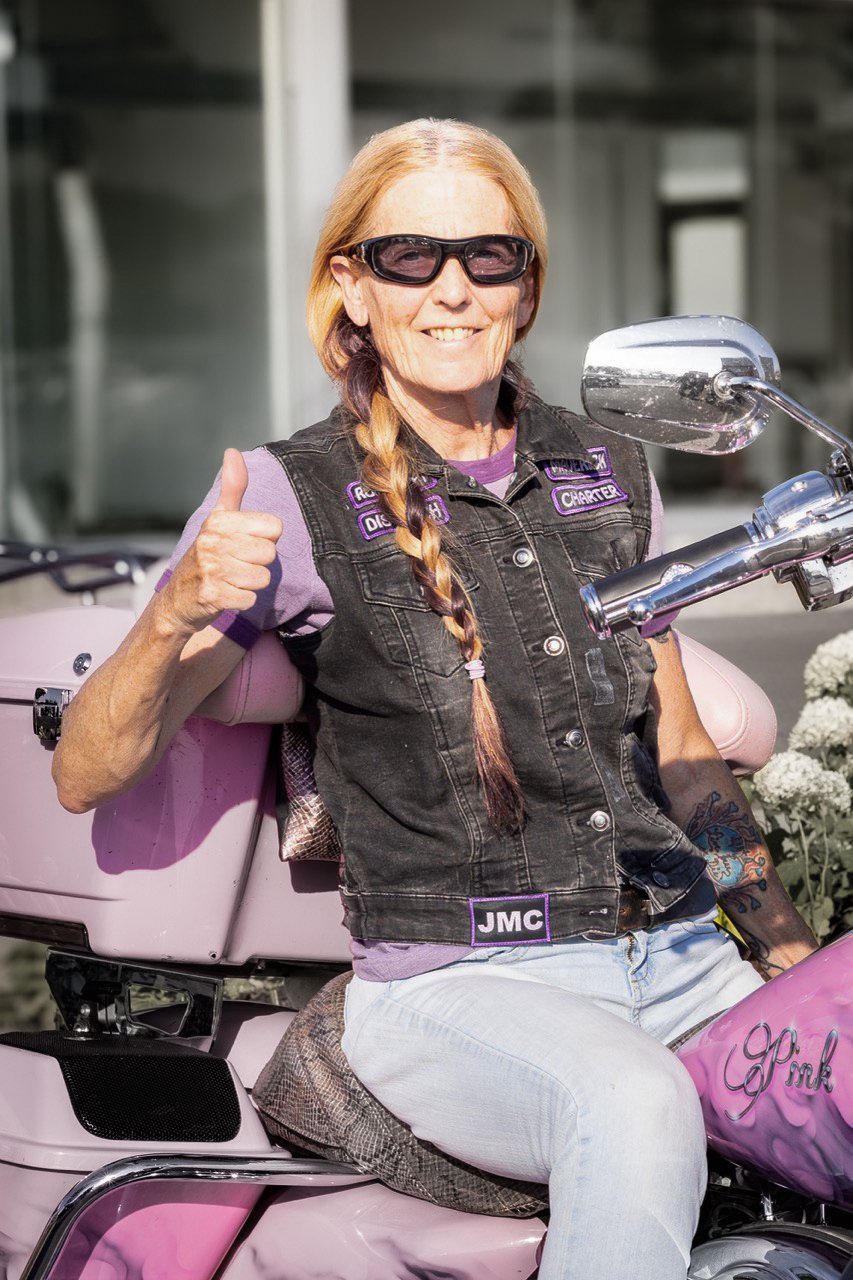 A candid portrait of a female biker.