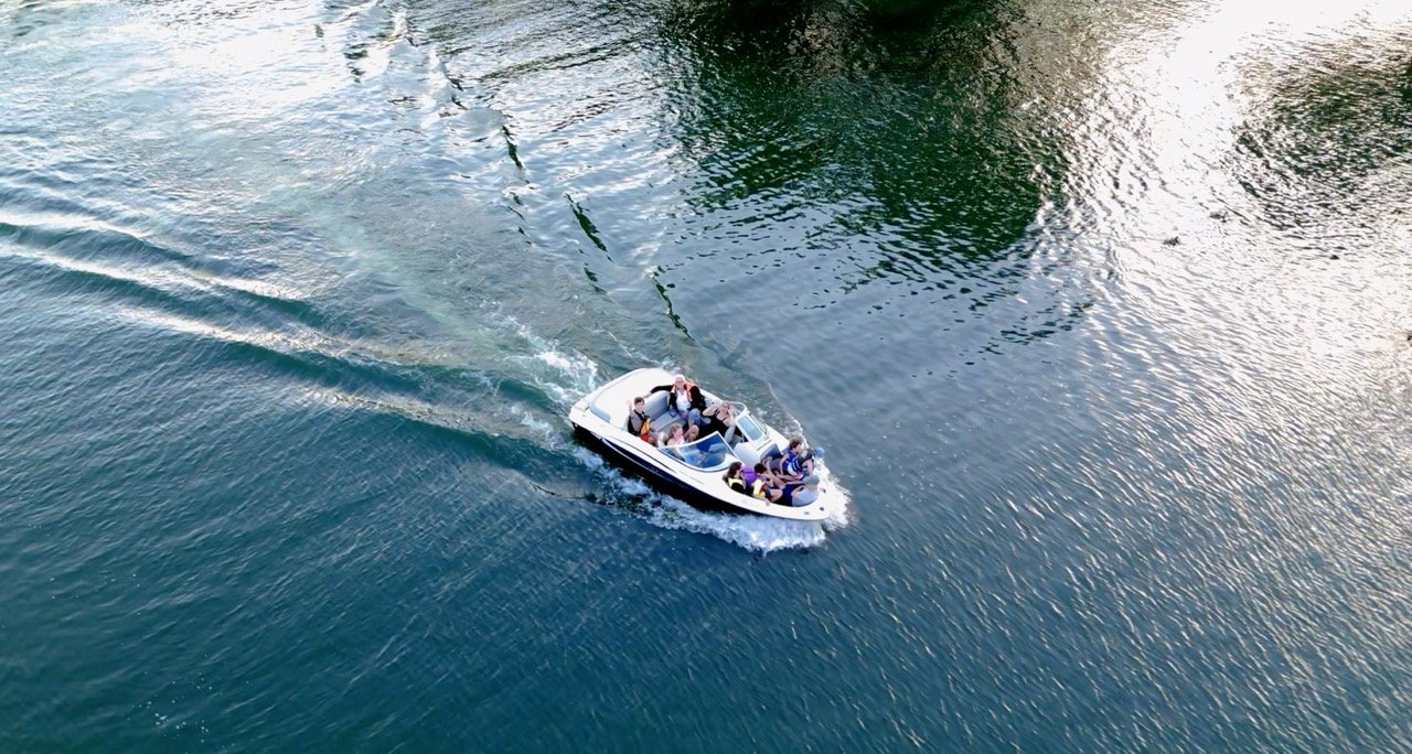 Aerial view of a motorboat creating a wake on the water.