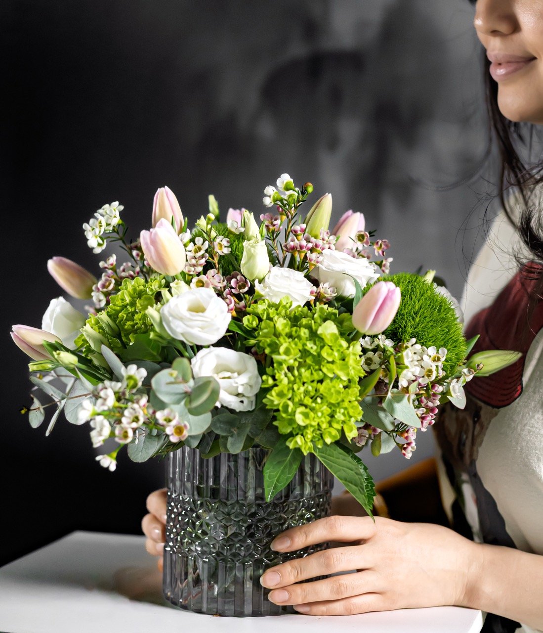 Still Life Photo of a person holding flowers.