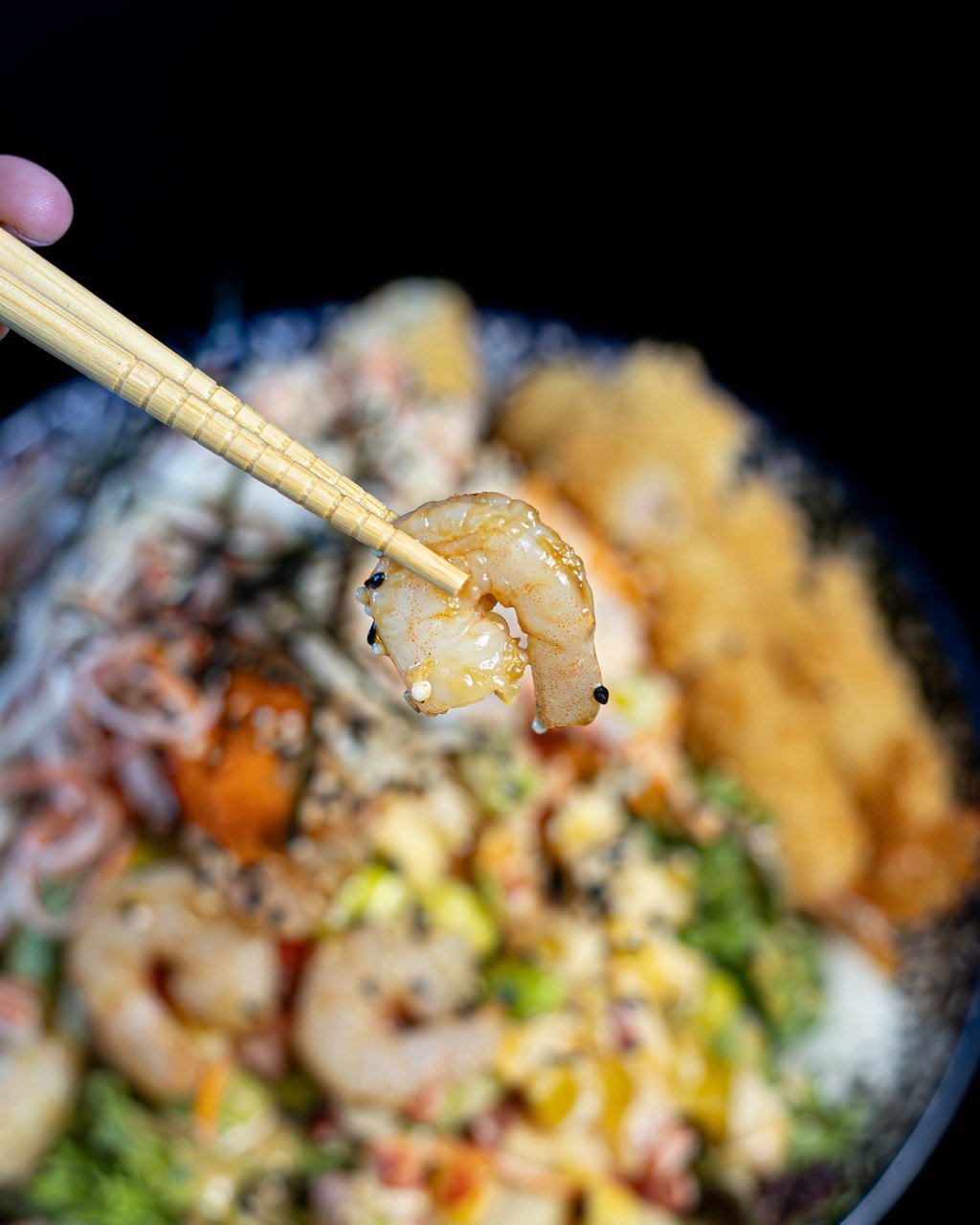 A top-down view of a young woman delighted by her meal.