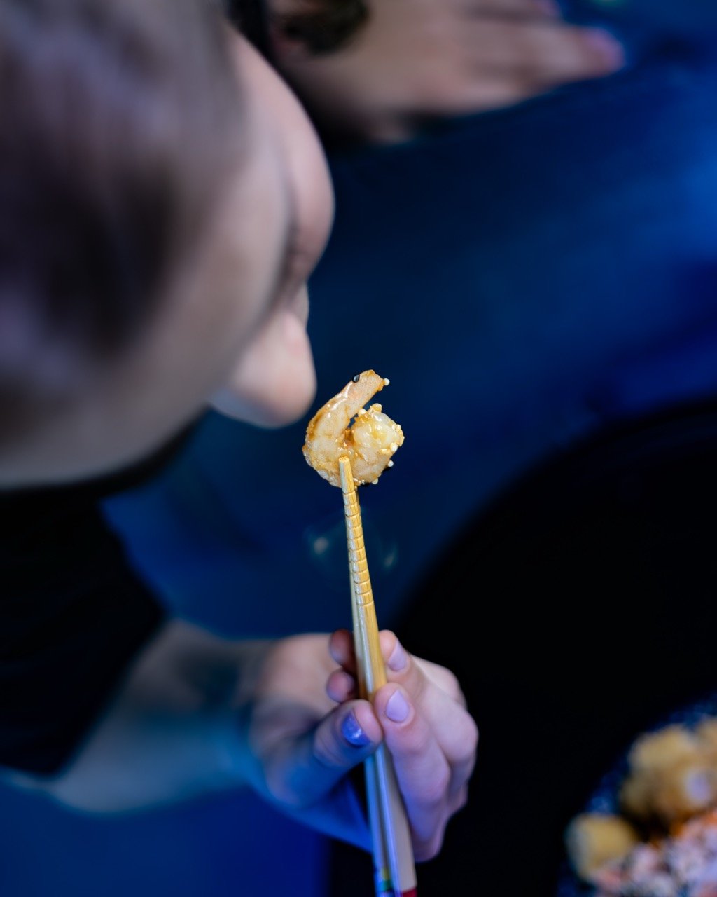 Hands presenting a beautifully prepared fusion bowl.