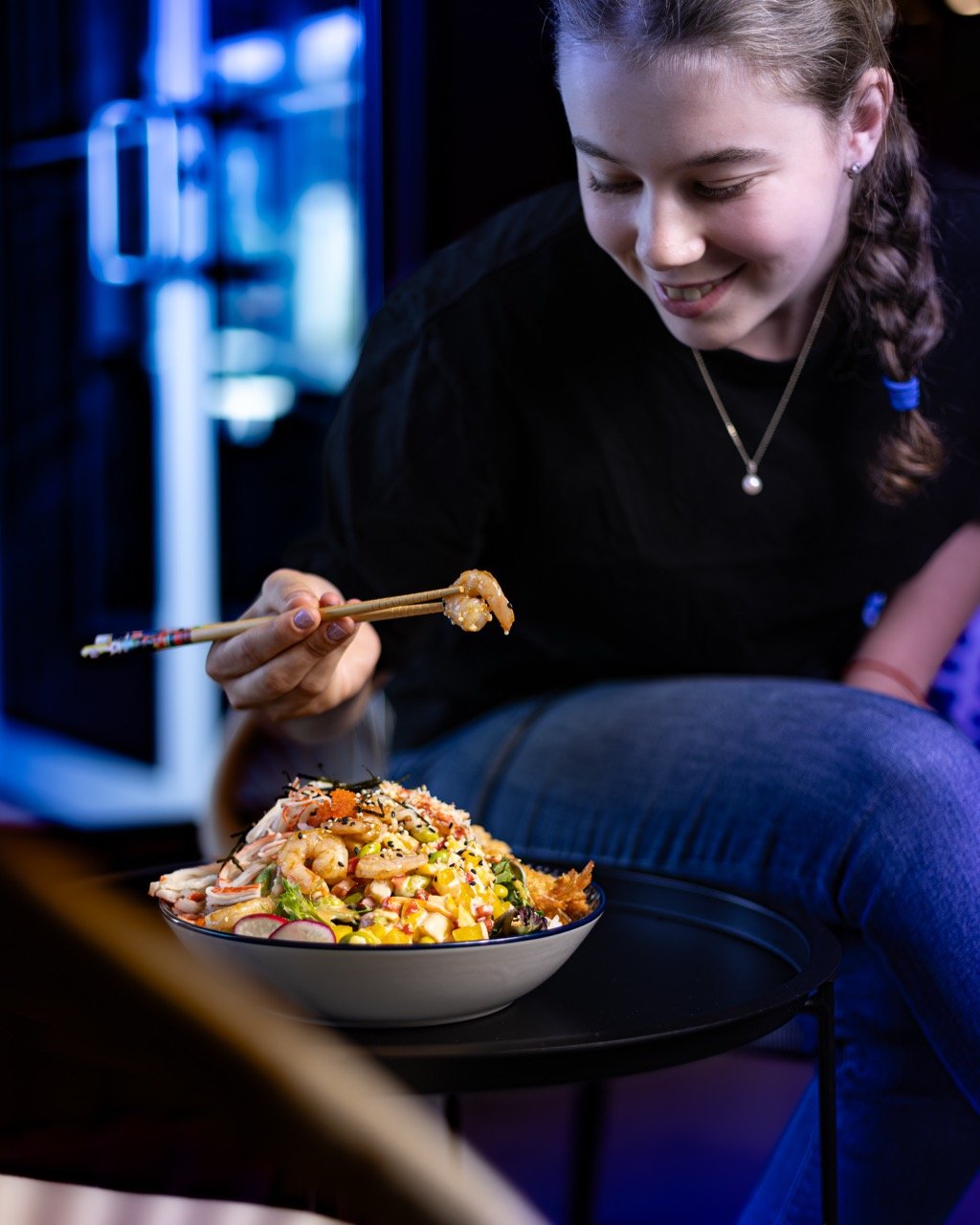 A colorful and appetizing fusion bowl with shrimp and noodles.